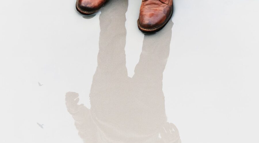 brown leather boots with reflected person